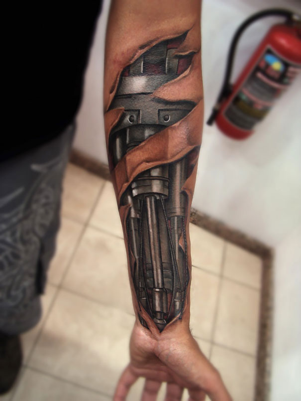 3D tattoo of cyborg mechanics on a forearm, creating a mind-twisting optical illusion.
