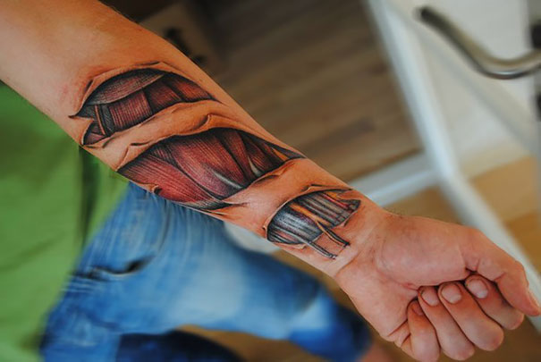 3D tattoo of muscle tendons on a forearm, creating a realistic and mind-bending optical illusion.