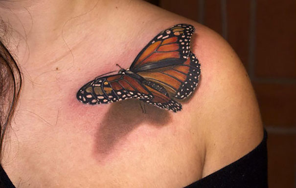 3D tattoo of a butterfly on a shoulder, showcasing realistic depth and vibrant colors.