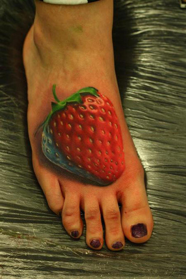 3D tattoo of a realistic strawberry on a foot, showcasing intricate design and vibrant colors.