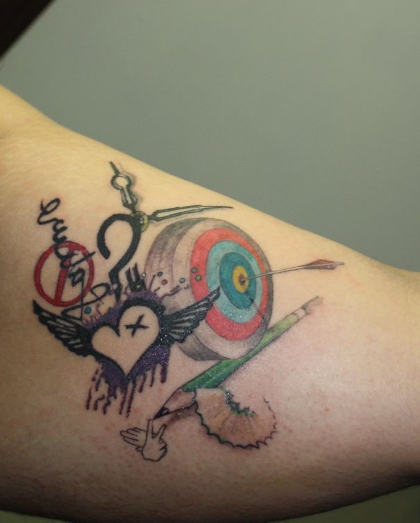 3D tattoo with a heart, arrow, pencil, and target design on arm.