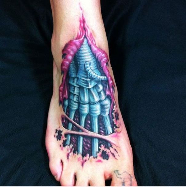Intricate 3D tattoo of a biomechanical design on a foot, creating a mind-twisting visual effect.