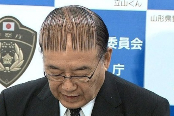 Man with a unique, pattern-shaped hairstyle in a formal setting, associated with crazy haircuts.