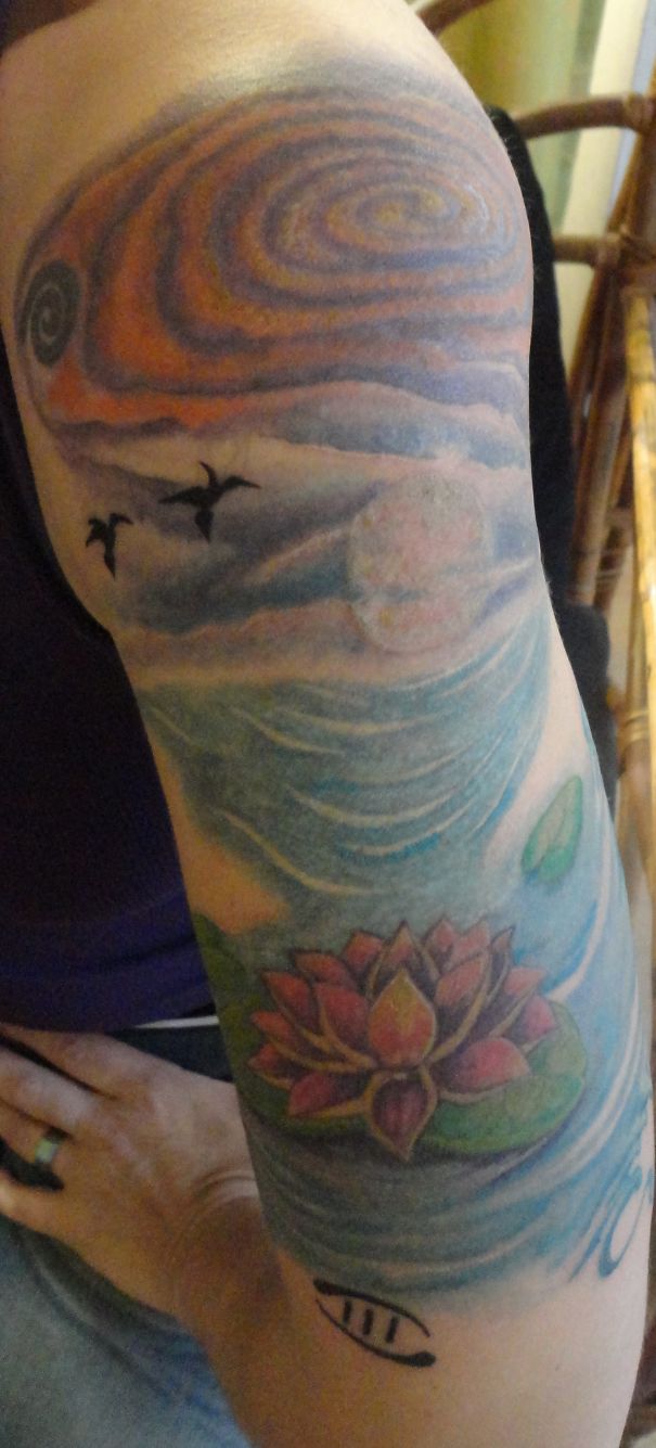 Colorful Father Universe and Mother Nature arm tattoo, featuring cosmic and nature elements for astronomy lovers.