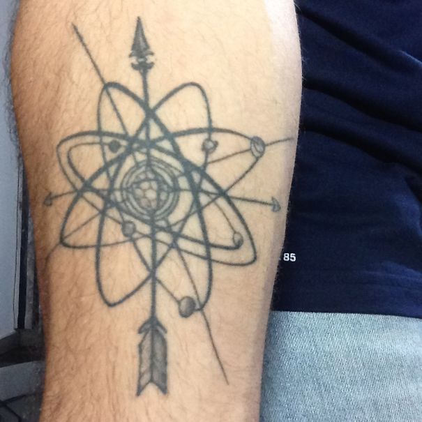 Astronomical arm tattoo featuring a cosmic design with orbits and an arrow.