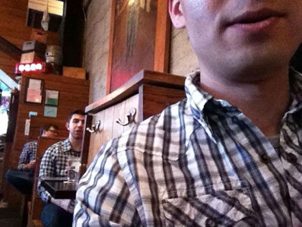 Three man sitting in the restaurant and wearing same shirts
