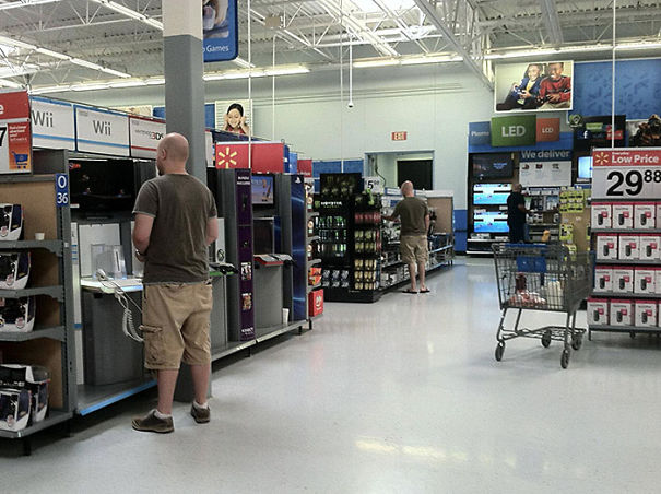 Two man at the store wearing same clothes 