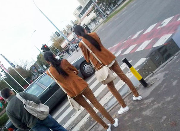 Two womans standing near each other and wearing same clothes