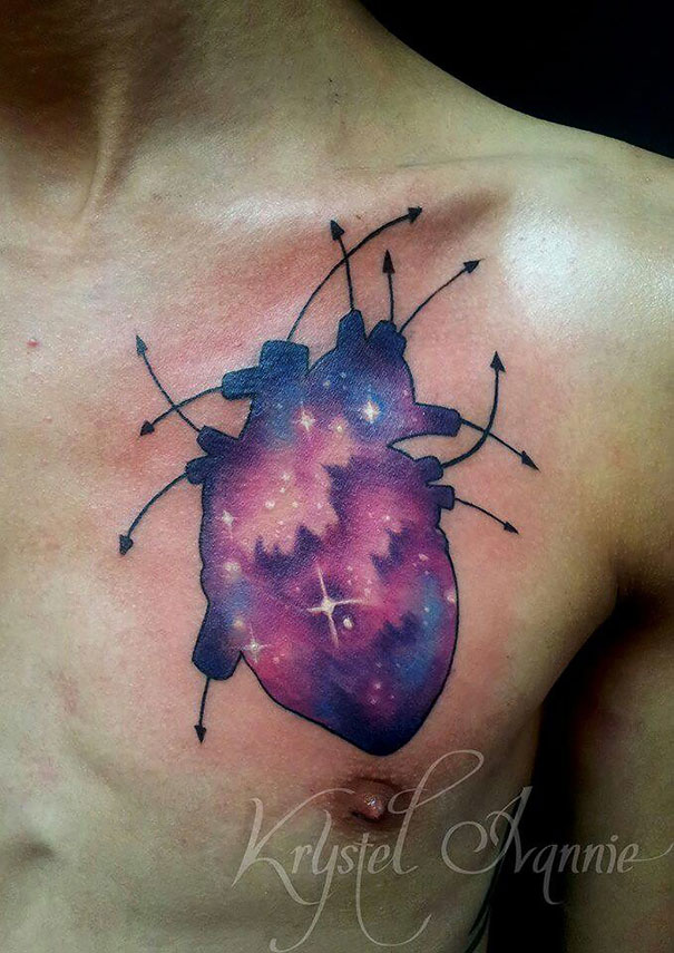 Colorful cosmic heart tattoo on chest for astronomy enthusiasts.