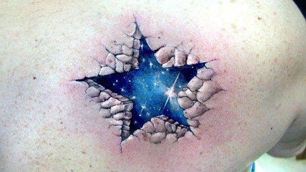 Colorful cosmic star tattoo on back with c*****d skin effect.
