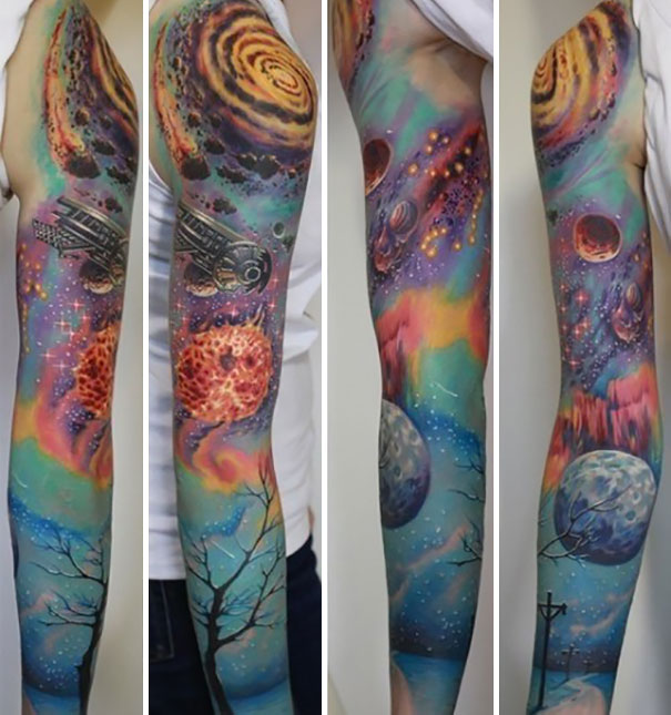 Colorful full sleeve arm tattoo featuring cosmic and astronomy themes with vibrant galaxies and planets.