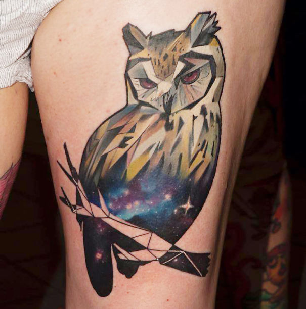 Colorful cosmic owl leg tattoo for astronomy lovers.