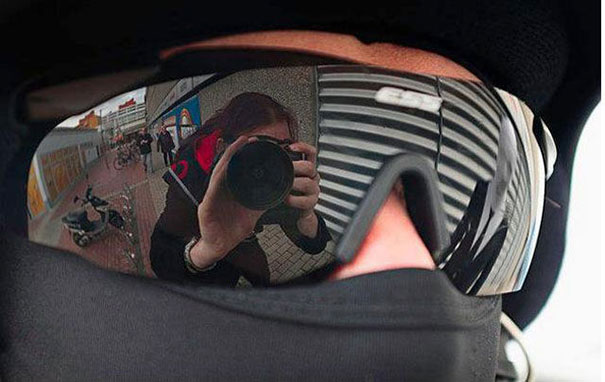 Reflection of a photographer in sunglasses, creating a surprising visual effect.