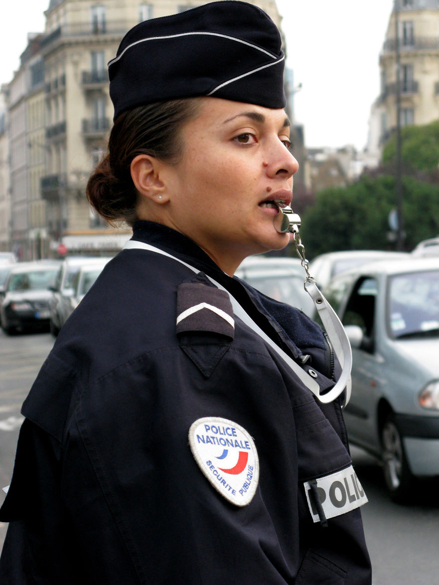 A Parisian Police Nationale Officer Eyes An Approaching Mob.