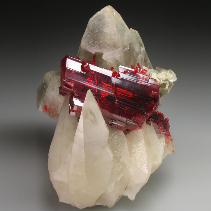 Red crystal formations on white mineral showcasing beautiful stones.