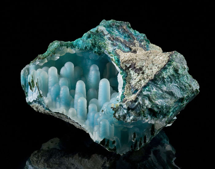 A stunning mineral with blue and green hues, showcasing unique crystal formations against a black background.