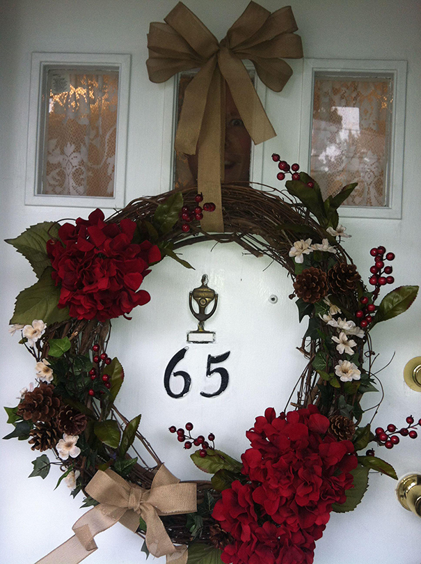 Festive door wreath with hidden face, surprising detail.