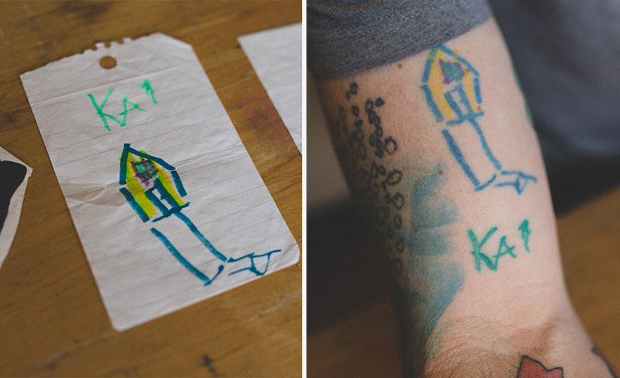 Child's drawing of a rocket on paper and tattooed on dad's arm, showcasing son's art.