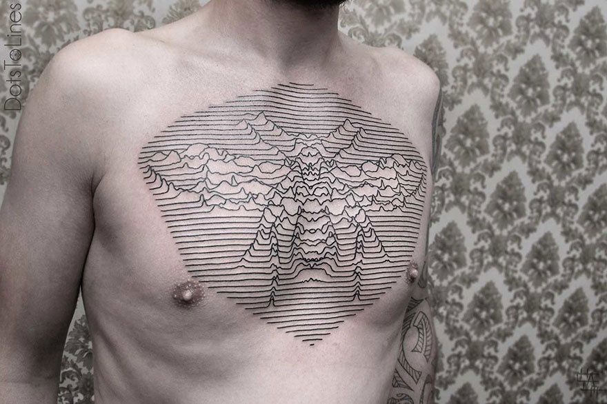 Geometric line tattoo by Chaim Machlev elegantly flows across a person's chest in intricate patterns.