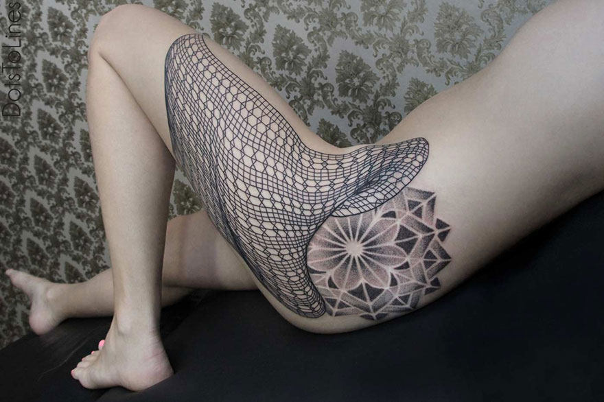 Geometric line tattoo by Chaim Machlev elegantly flows over a person's thigh with intricate black ink patterns.