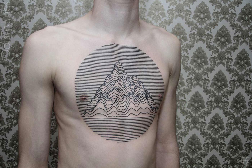 Geometric line tattoo by Chaim Machlev on chest, featuring elegant mountain-like design.