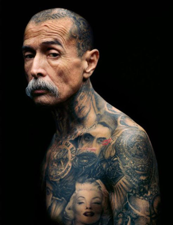 Tattooed senior with intricate full-body ink, showcasing how tattoos age beautifully on mature skin.