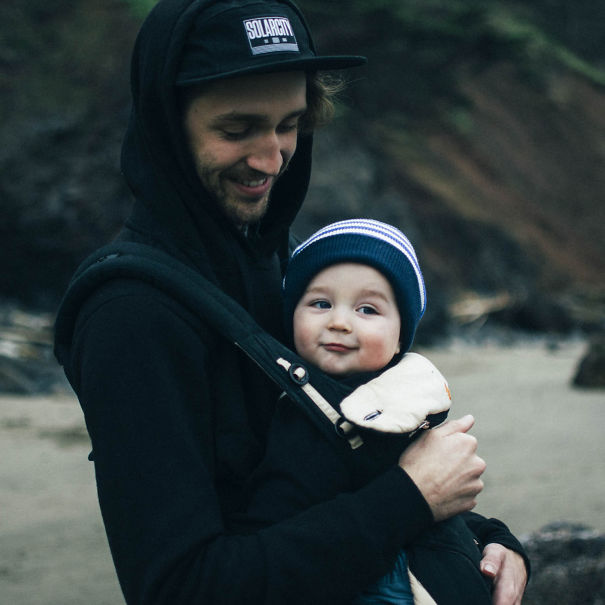 Father teaching alphabet by drawing one animal letter A day, holding his baby outdoors in a nature setting Father teaching alphabet by drawing one animal letter A day, holding his baby outdoors in a nature setting
