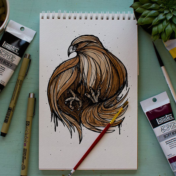 Sketchpad with brown bird drawing surrounded by acrylic paints and brushes in an animal letter a day alphabet teaching setup Sketchpad with brown bird drawing surrounded by acrylic paints and brushes in an animal letter a day alphabet teaching setup