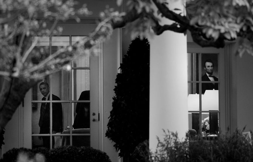 President Barack Obama Stands In The Oval Office Of The White House, Washington, D.c.