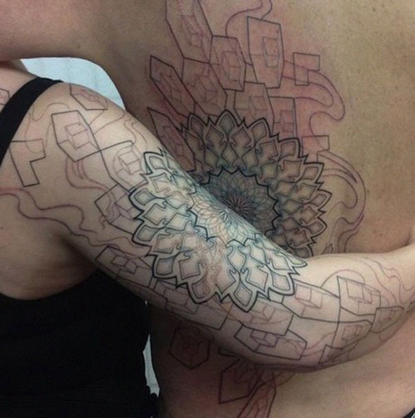 Matching couple tattoos forming a geometric pattern on arms and back.