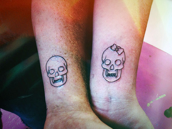 Matching couple tattoos featuring cute skull designs on wrists, symbolizing love that lasts.