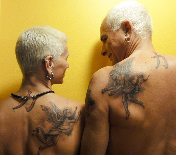 Couple with matching angel tattoos on their backs, symbolizing eternal love.