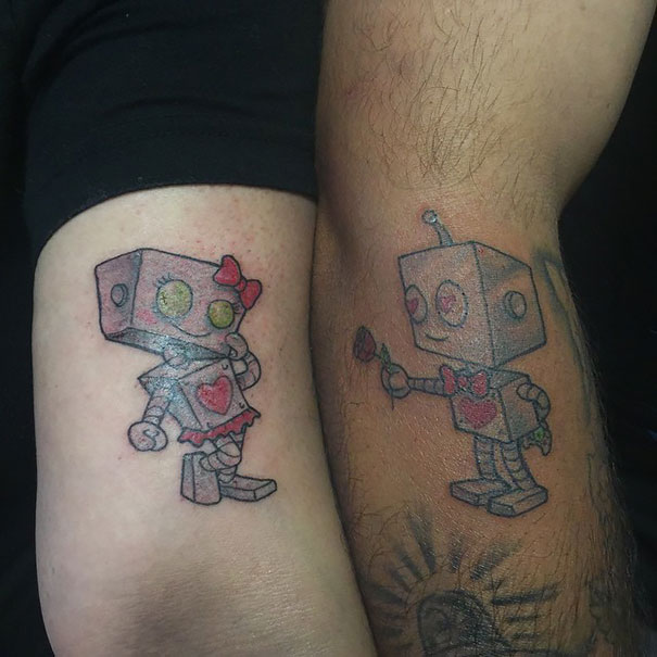 Robot couple tattoos symbolizing love and unity for couples.