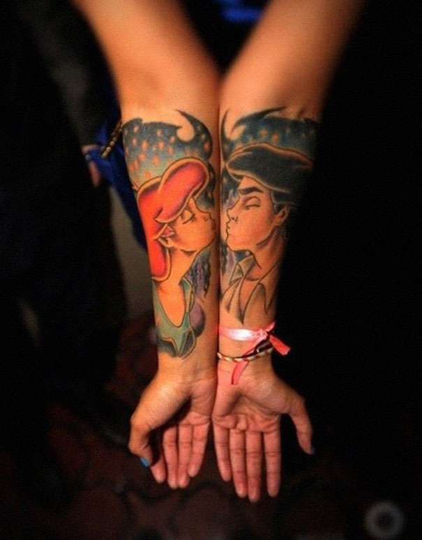 Matching couple tattoos on forearms featuring animated characters, symbolizing love and longevity.