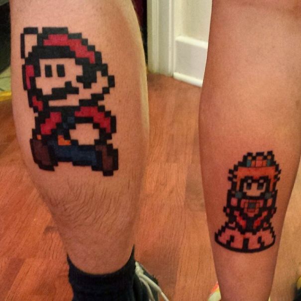 Pixel art matching couple tattoos of game characters on legs.