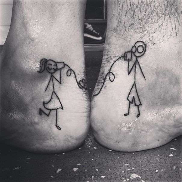 Matching couple tattoos with stick figures using tin can telephones, symbolizing connection and communication.