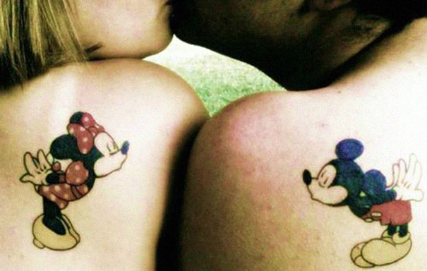 Couple tattoos of Mickey and Minnie Mouse on shoulders, symbolizing matching love for partners growing old together.