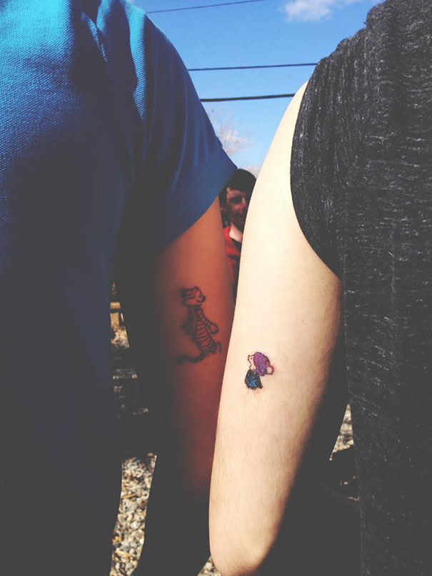 Couple's matching tattoos on arms, featuring whimsical designs, symbolizing love that will grow old together.