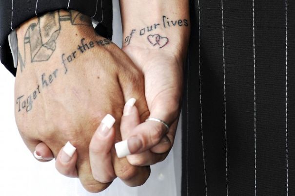 Couples holding hands with matching tattoos expressing eternal love.