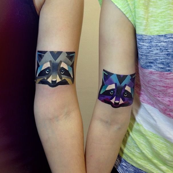 Matching couple tattoos of geometric raccoons on arms, symbolizing enduring love for growing old together.