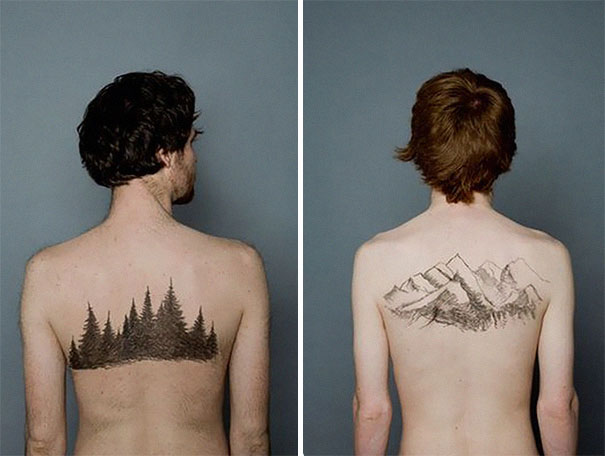 Couple showing matching landscape tattoos on their backs, featuring trees and mountains, symbolizing love and togetherness.