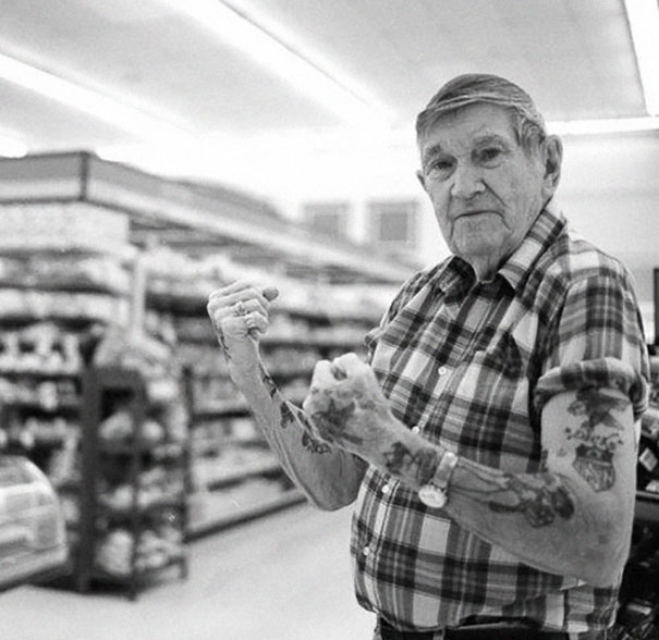 Senior showing arm tattoos in a plaid shirt, demonstrating how ink looks at age 60.