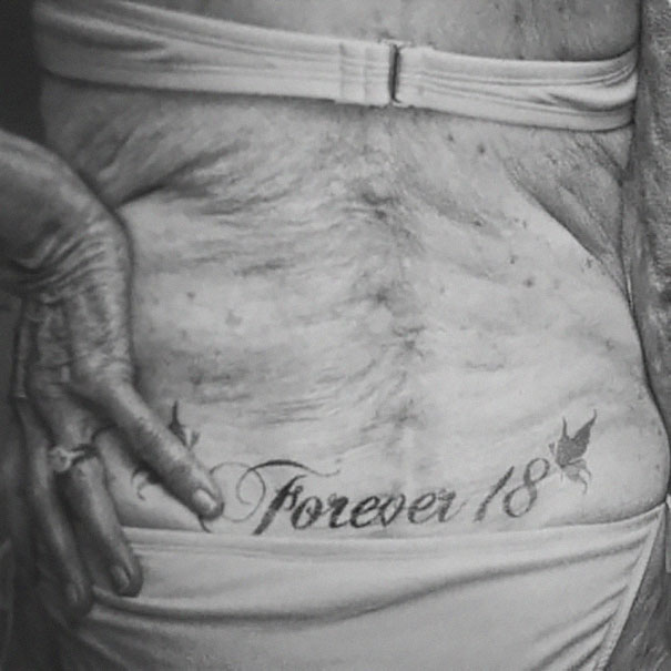 Elderly person with "Forever 18" tattoo on lower back, illustrating tattooed seniors.