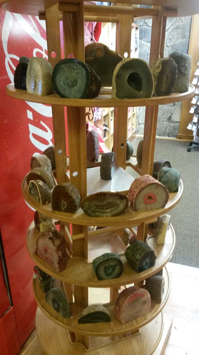 Beautiful minerals and stones displayed on a wooden rotating rack indoors.