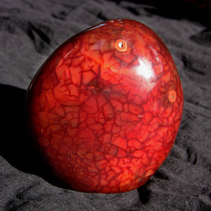 Shiny red mineral with intricate patterns, representing beautiful stones.