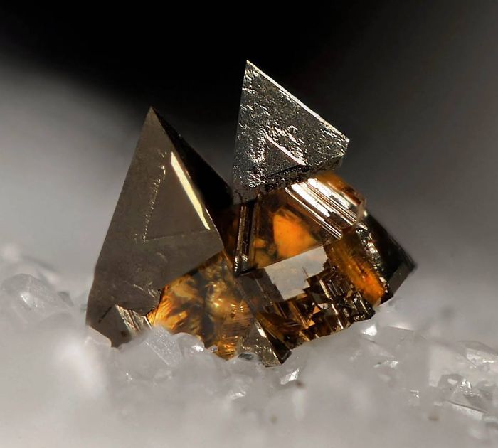 A stunning mineral with sharp geometric formations on a white background.