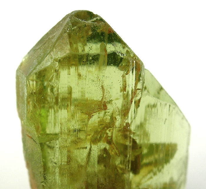 Close-up of a green crystal mineral, showcasing its translucent beauty and natural formations.