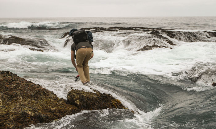 Grabbing The Tripod As A Wave Surges By. Laguna Beach