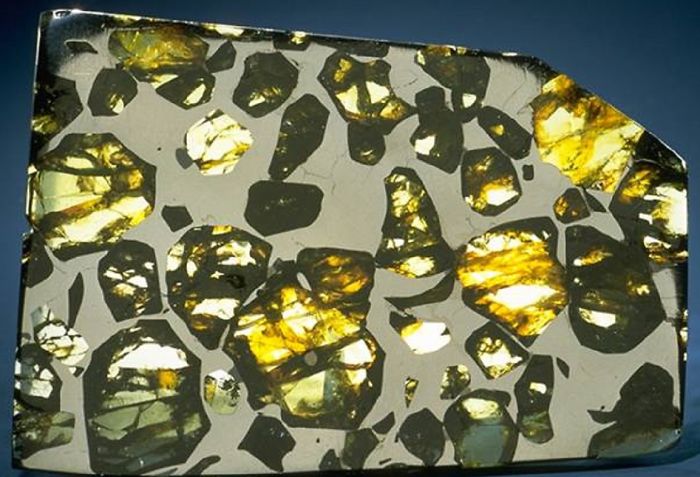 Beautiful minerals in a polished stone with golden and green patterns, showcasing natural artistry.