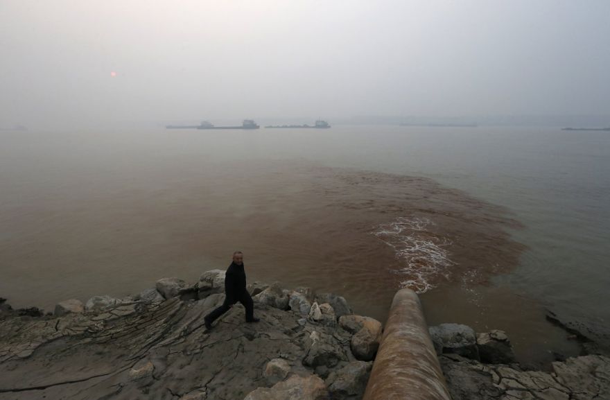 Man Walks Next To Polluted Water Supply; Beijing, China